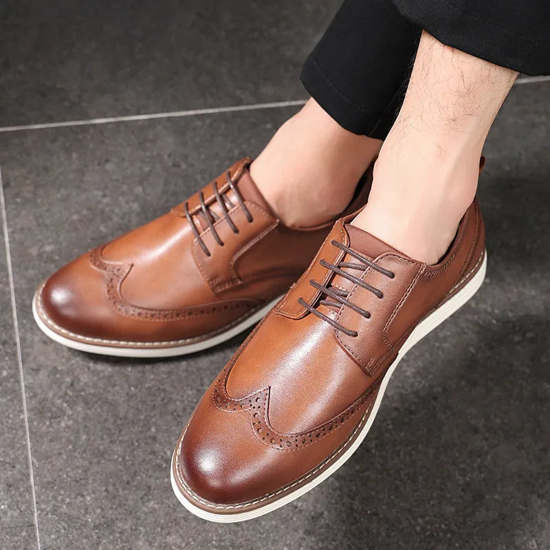 Men's black slip-on business casual shoes with decorative carving on the PU leather upper