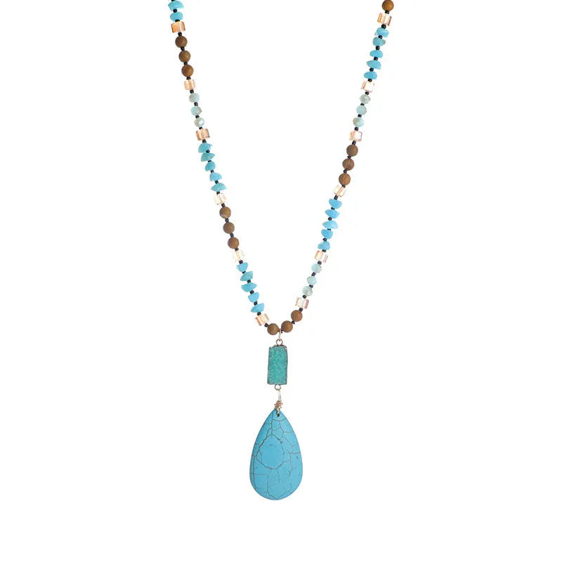 Long turquoise blue water drop pendant necklace with mixed gem inlay on a ball bead chain for women.