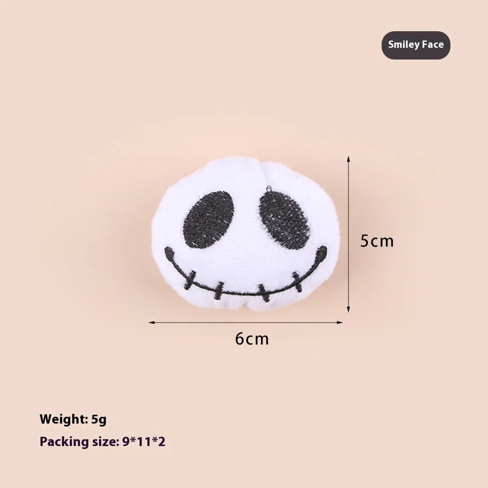 Small cat teaser toy with eyes, candy and skull plush designs on lightweight wand