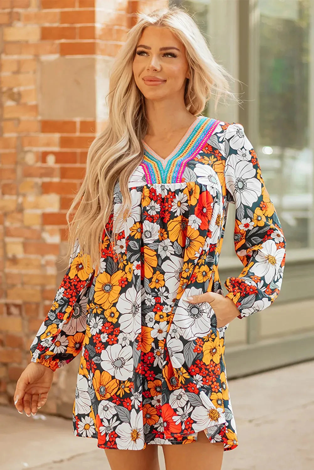 Orange floral print mini dress with V-neck, long sleeves, and striped lace detailing