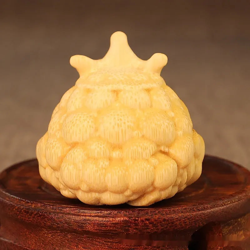 Solid bamboo carving of a cute style Crown Princess Toad ornament on display