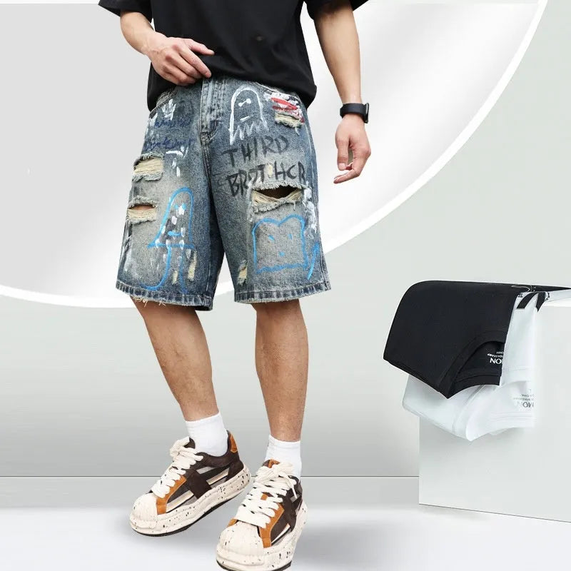 Blue distressed denim shorts with graffiti detail and ripped styling on mannequin