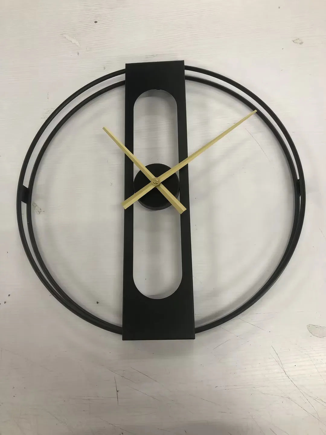 Round metal wall clock with 50cm diameter face in black or gold finish.