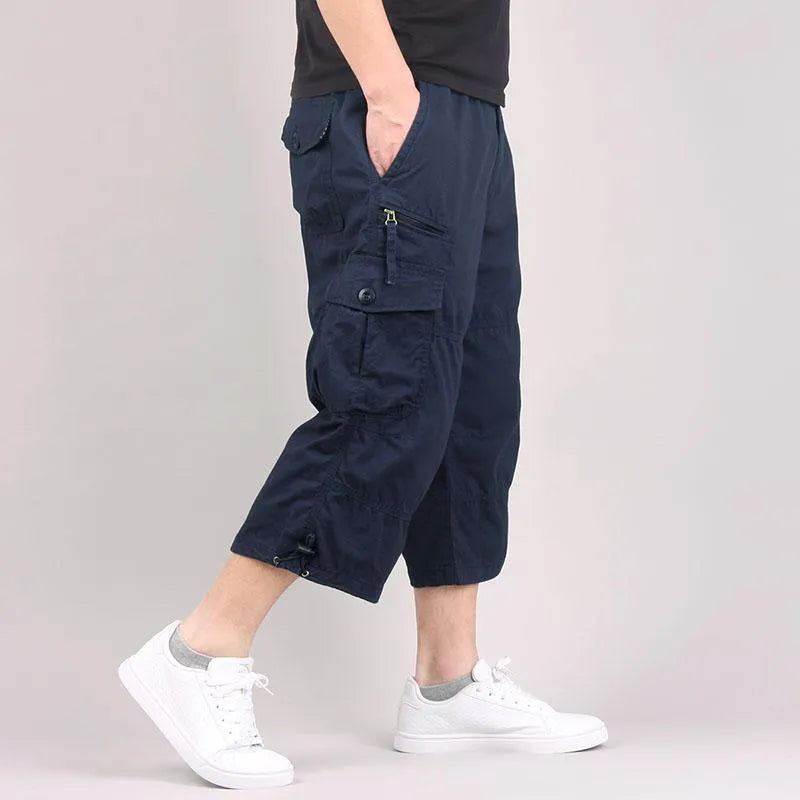 Men's loose fit cotton cropped casual pants in khaki colour on a neutral background.
