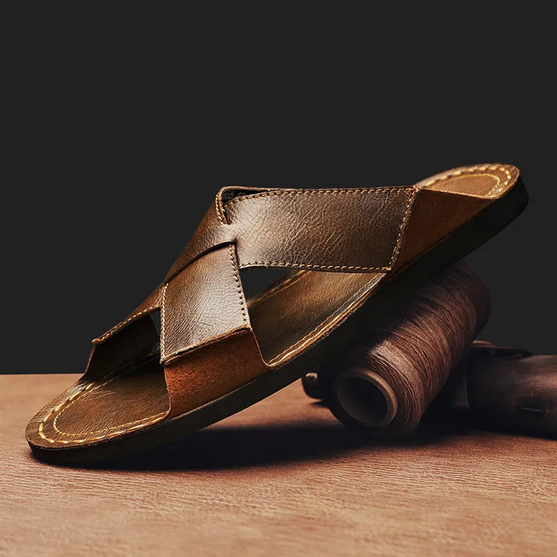 Men's black genuine leather slip-on sandals with a rubber sole on a plain background.