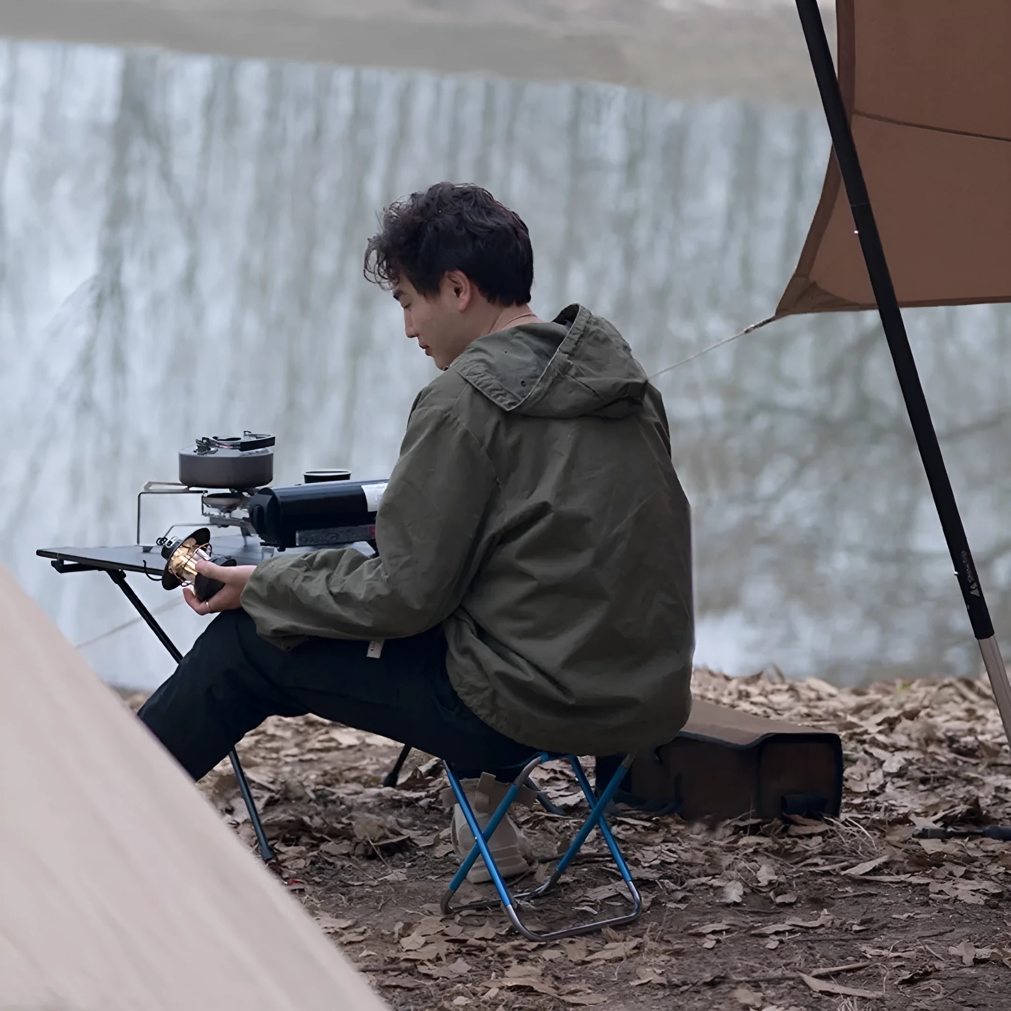 Black aluminium alloy folding camp stool with ethnic pattern, shown in folded and open positions.