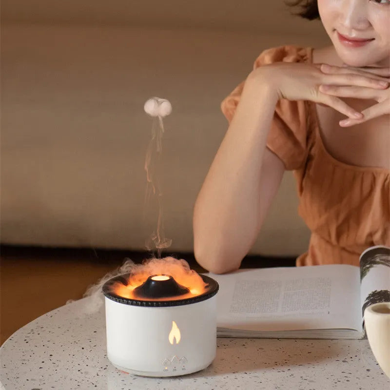 Volcanic-shaped humidifier emitting a two-colour mist from its spray ring on a table.