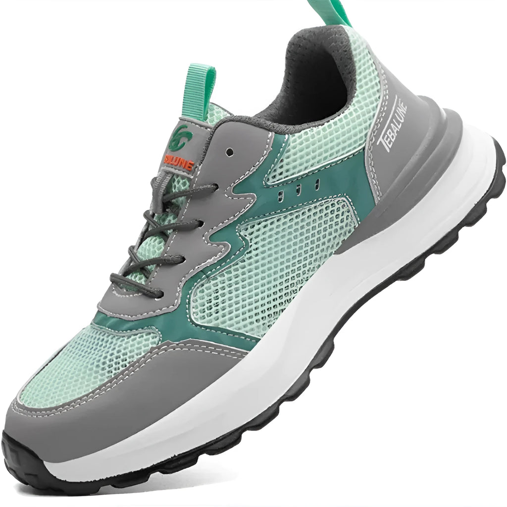 Green low-top work shoe with plastic toe cap, mesh panels, and slip-on design on a TPU sole.