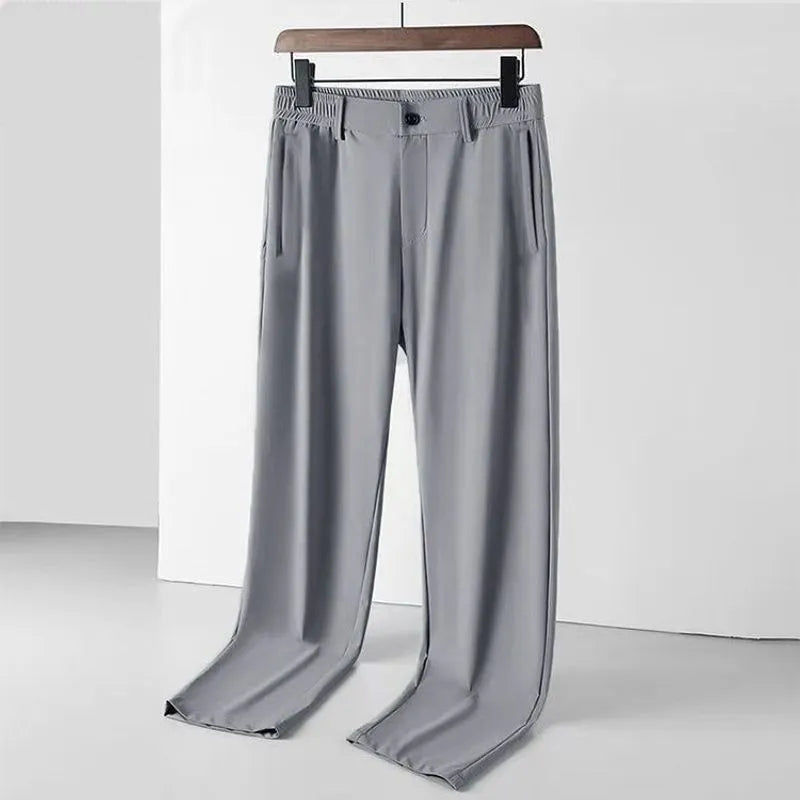 Man wearing black ice silk loose straight-leg trousers with a high elasticity open waist.