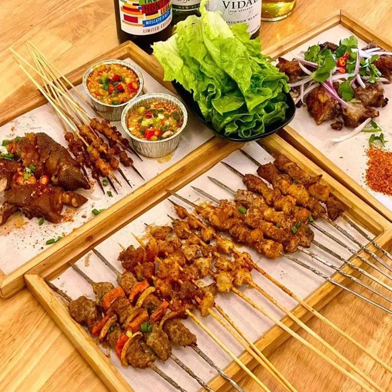 Brown handle square bamboo serving tray on a table.