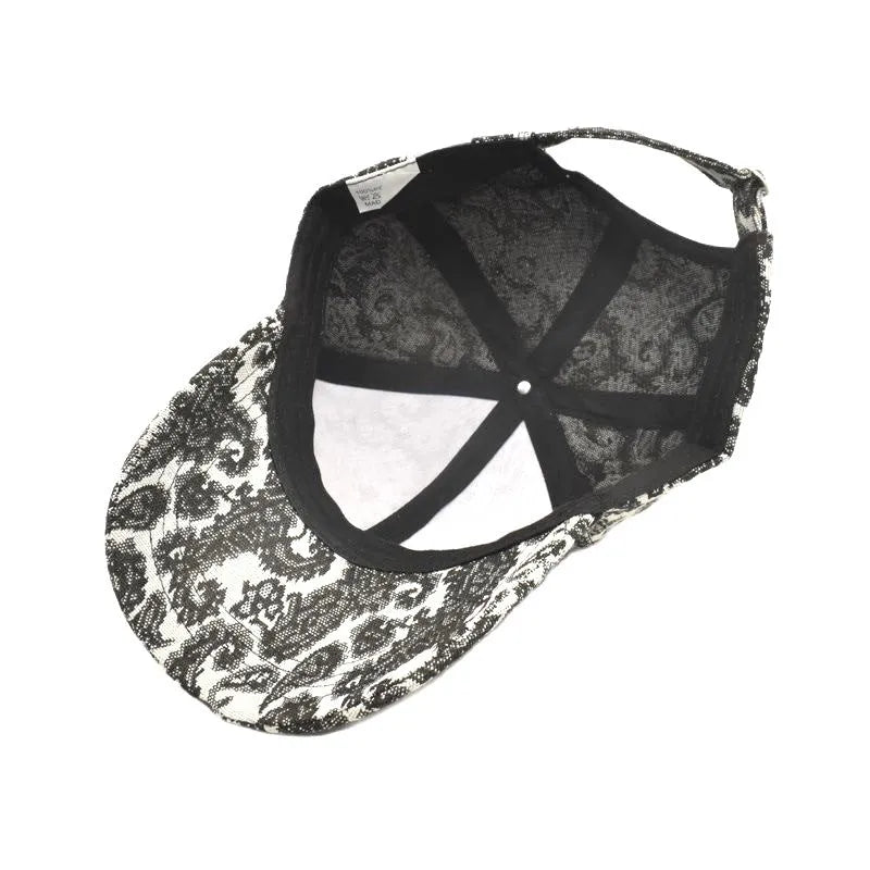 Blue polyester baseball cap with a white paisley pattern print and a dome crown.
