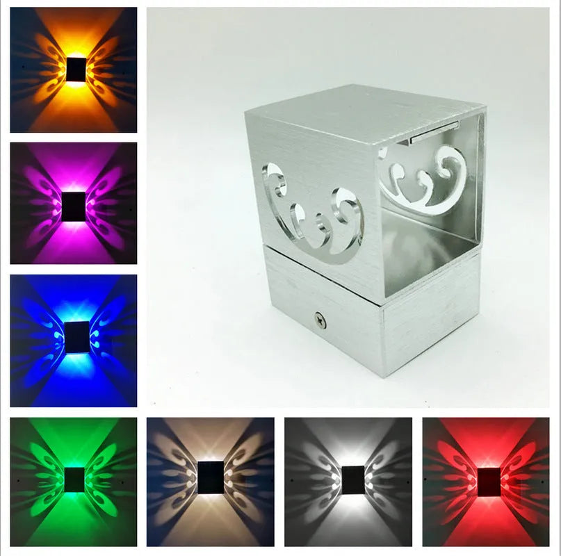Modern aluminium butterfly-shaped LED wall lamp with remote control for changing light colours.