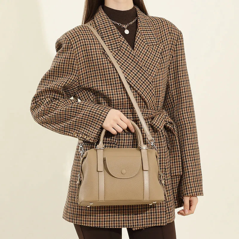 Genuine leather street style handbag for women with adjustable shoulder strap.