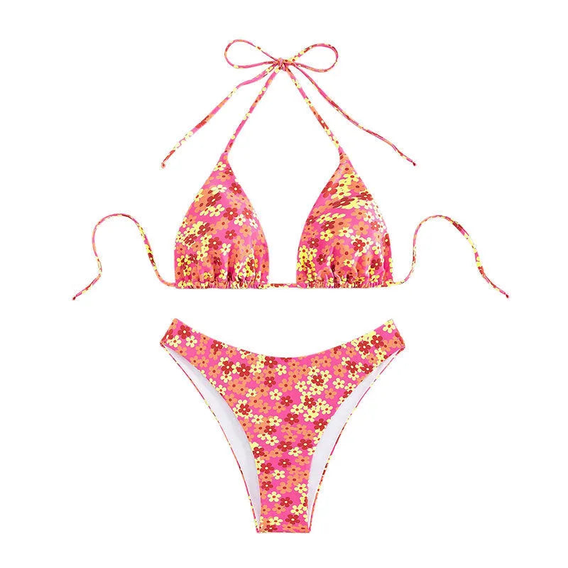 Women's blue printed swimsuit with lace-up front and high split leg shorts.
