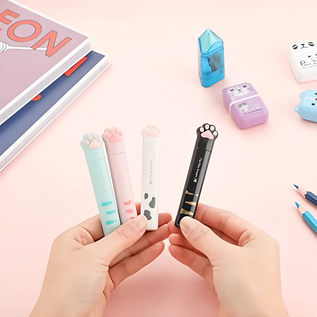 Closed folding mini scissors with cat paw design on handles in blue, pink, black, and white colour options.