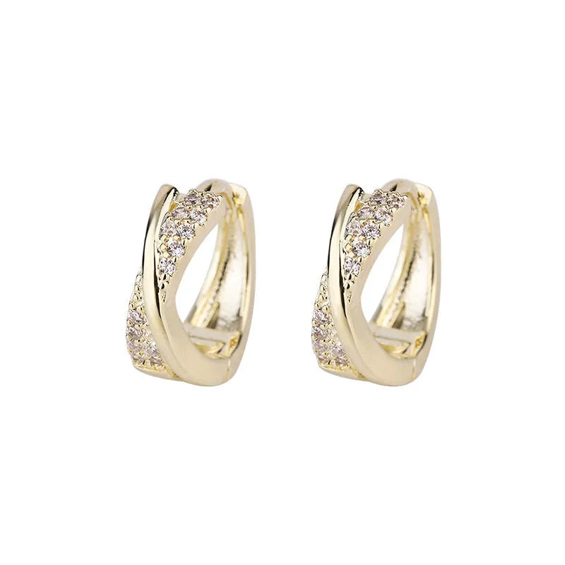 A pair of geometric stud earrings with zircon stones and a 14K yellow finish.