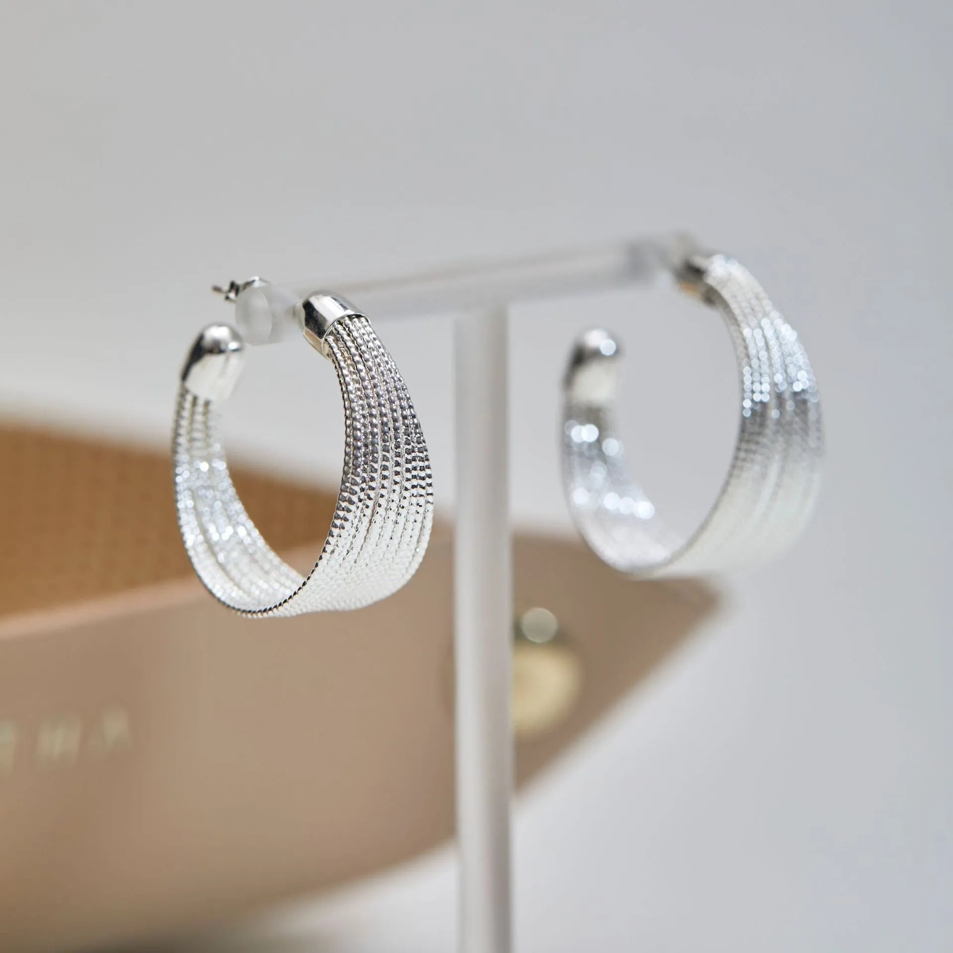 Geometric multi-layer copper earrings with silver or gold electroplated finish, showing stud and clip options