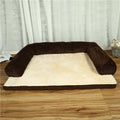 Corduroy pet sofa dog bed with bolster, shown in a grey colour on a wooden floor.