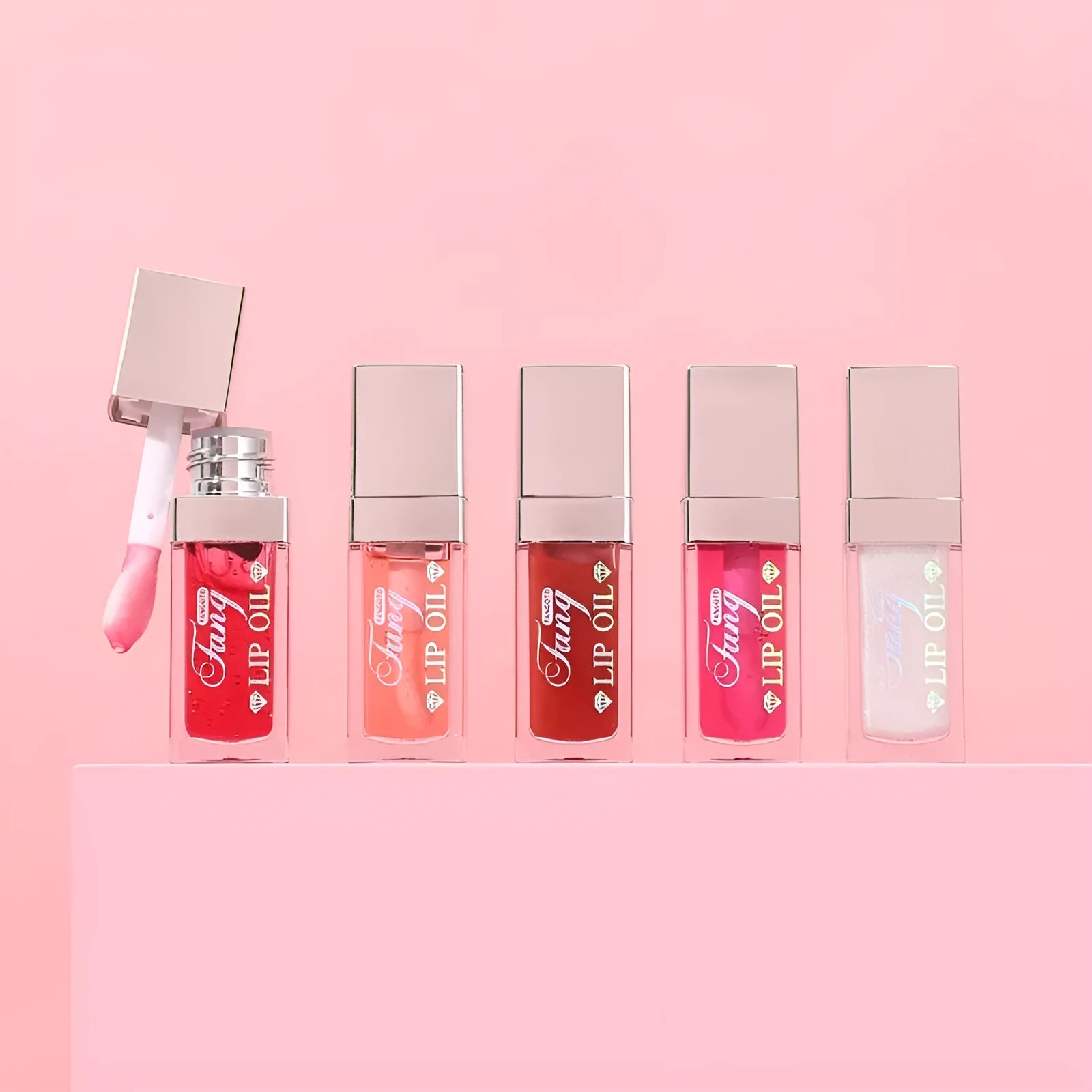 Mint lip gloss and lipstick set showing five bright colour options with lip essence oil
