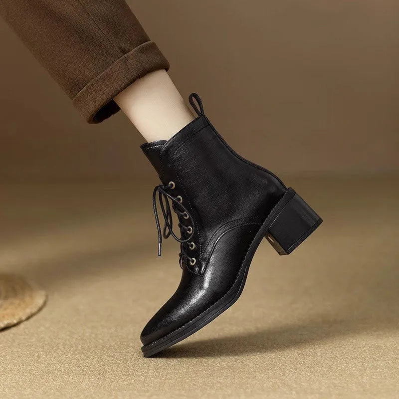 Women's black pointed-toe ankle boots with block heel and short shaft design