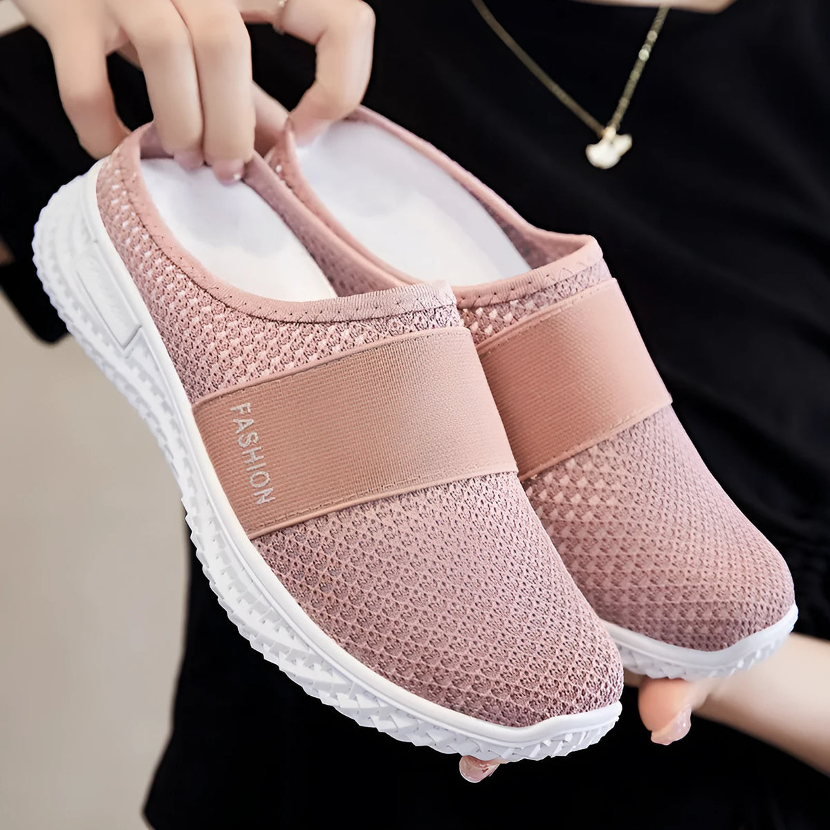 Women's flat casual shoes with mesh upper and hollow-out design in black, grey, pink, or purple.