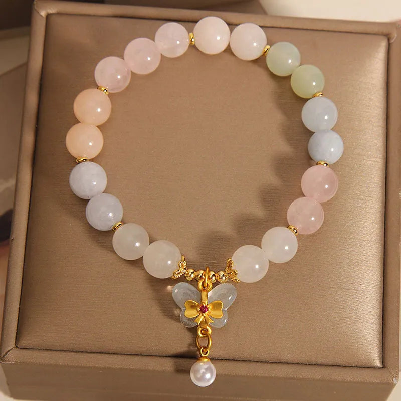 Close-up of a women's adjustable crystal bracelet with a colourful Morganite butterfly pendant.