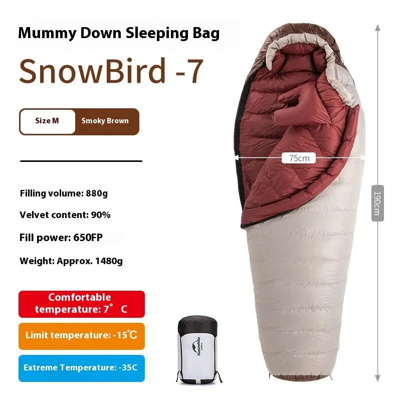 Mummy style goose down sleeping bag for adults shown with its storage bag