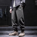 Men's grey ankle-tied straight-leg sweatpants laid flat, showing non-ironing casual design.