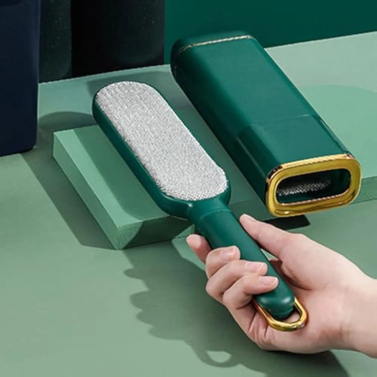 Reusable pet hair remover brush with a plush head and storage base, shown in blue, green and white colour options.