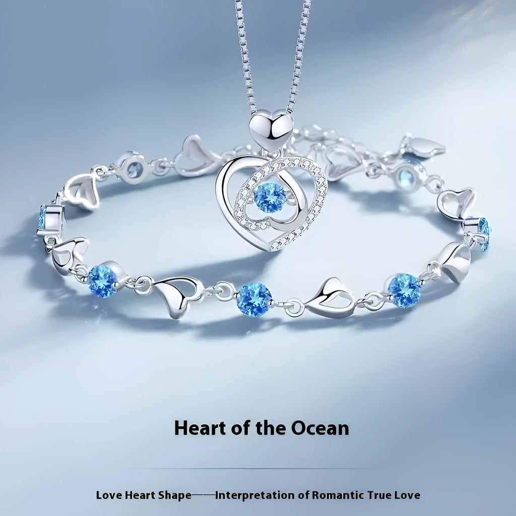 Blue diamond heart-shaped necklace and bracelet set with geometric pendant and mixed gem inlay on an adjustable copper chain.