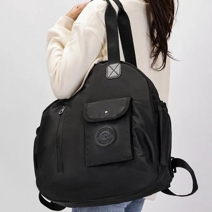Large lightweight nylon backpack in black, khaki, or green with front sandwich pocket.