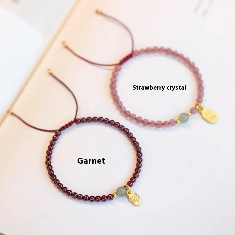 Hand-woven red rope bracelet with strawberry quartz and garnet beads in national tide style