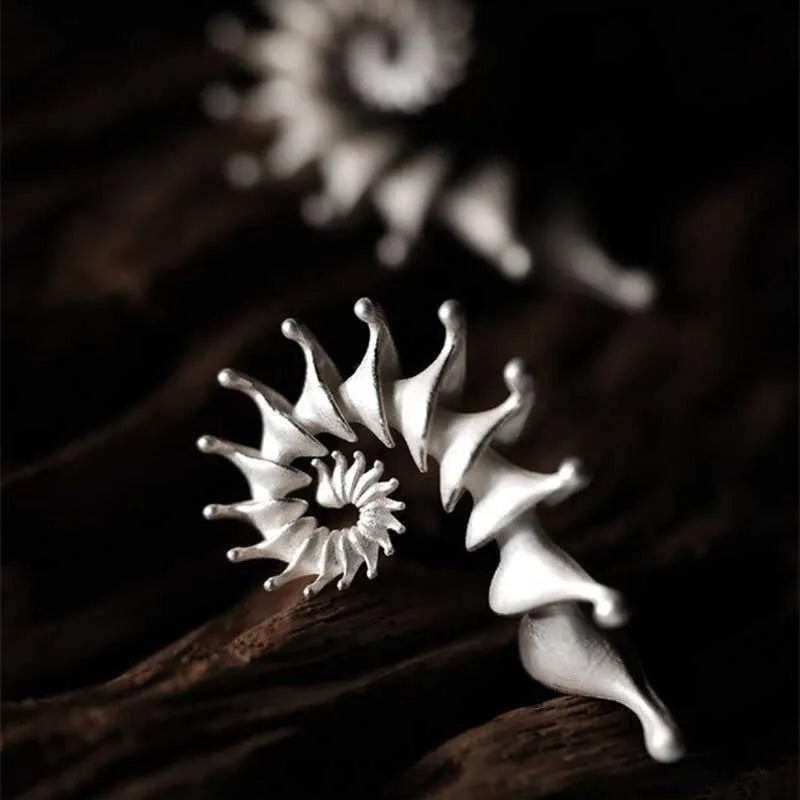 Conch coloured geometric stud earrings with three-dimensional matte finish