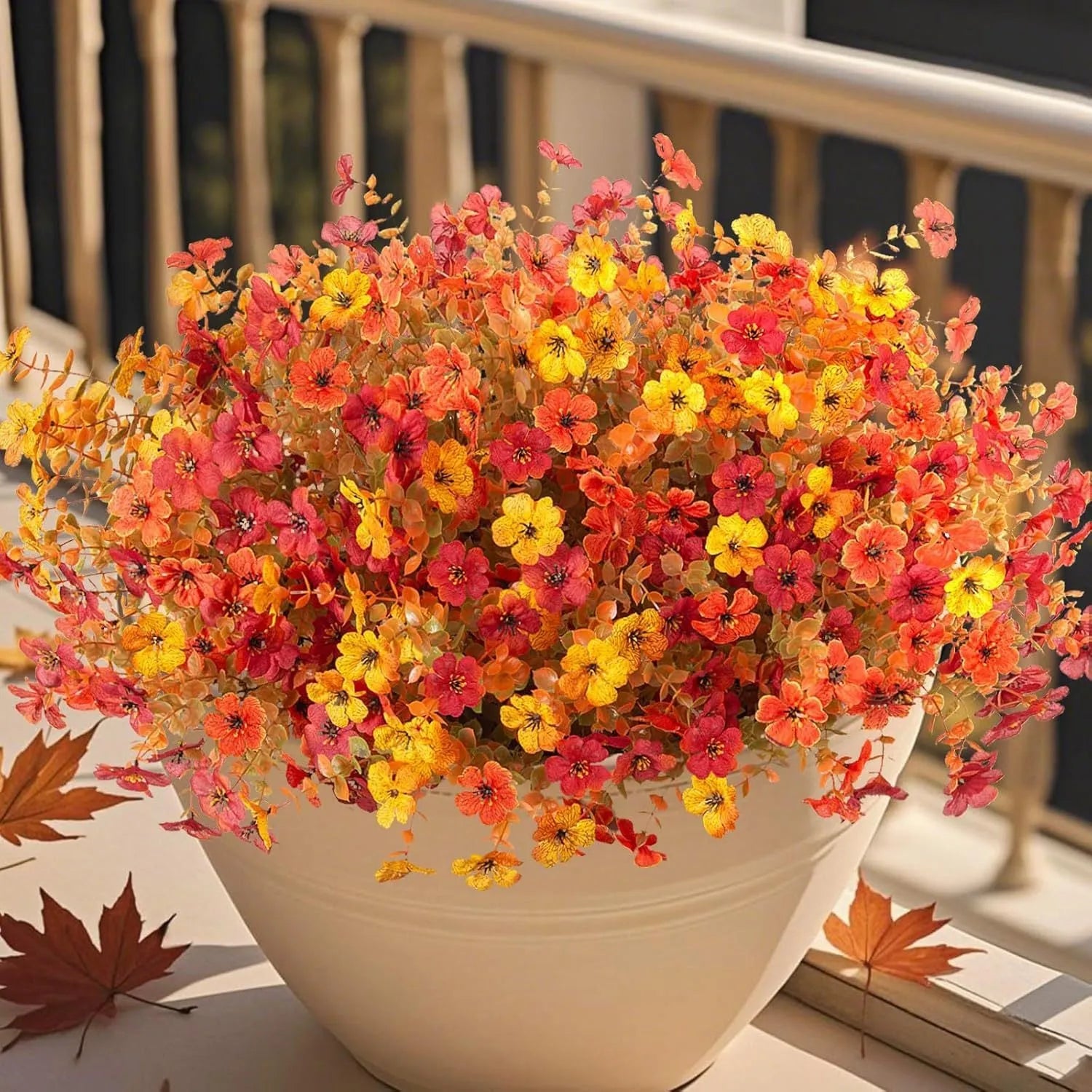 Artificial flower bouquet in autumn orange, red, and yellow colours for home or wedding decoration.