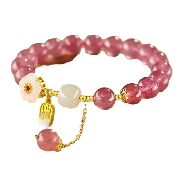 Handmade strawberry quartz crystal bracelet for women showing natural bead details on wrist
