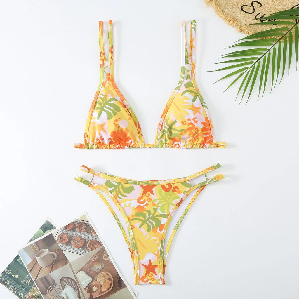 Women's floral printed halter neck bikini set in blue on a mannequin.
