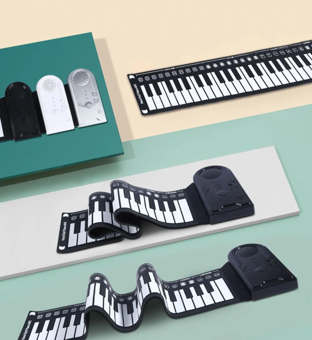 Portable black folding electronic keyboard rolled up next to its control panel and cable.