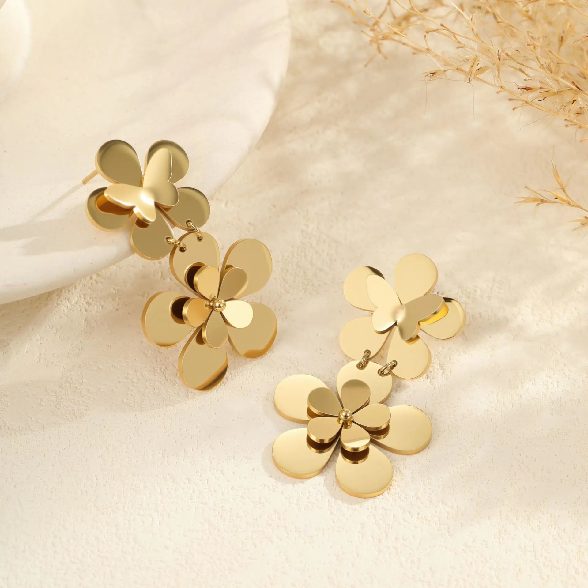 Women's stainless steel earrings with gold electroplated finish and floral butterfly design
