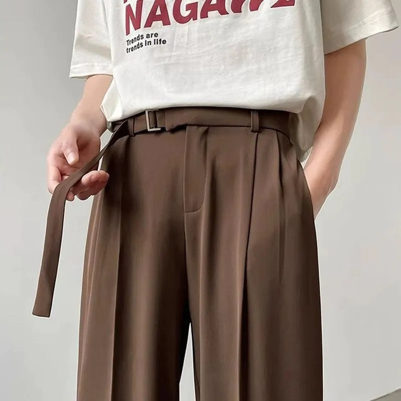 Women's black wide leg straight cut trousers with a non-iron finish on a neutral background