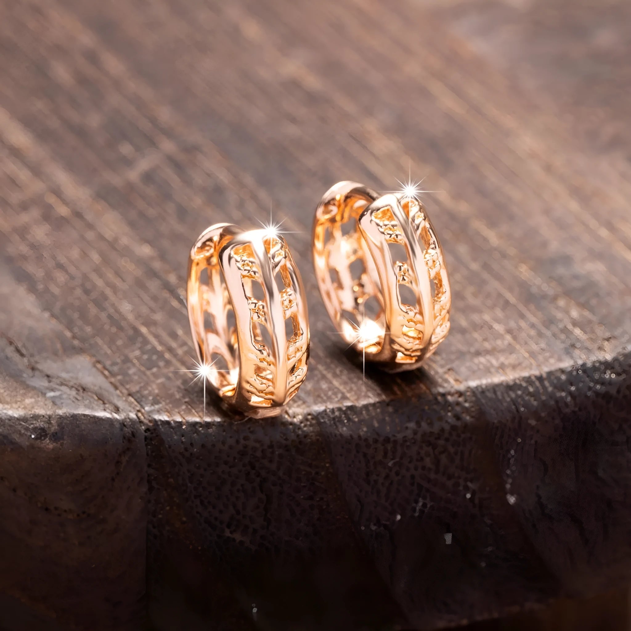 Rose gold copper earrings with hollowed-out heart and leaf designs on white background