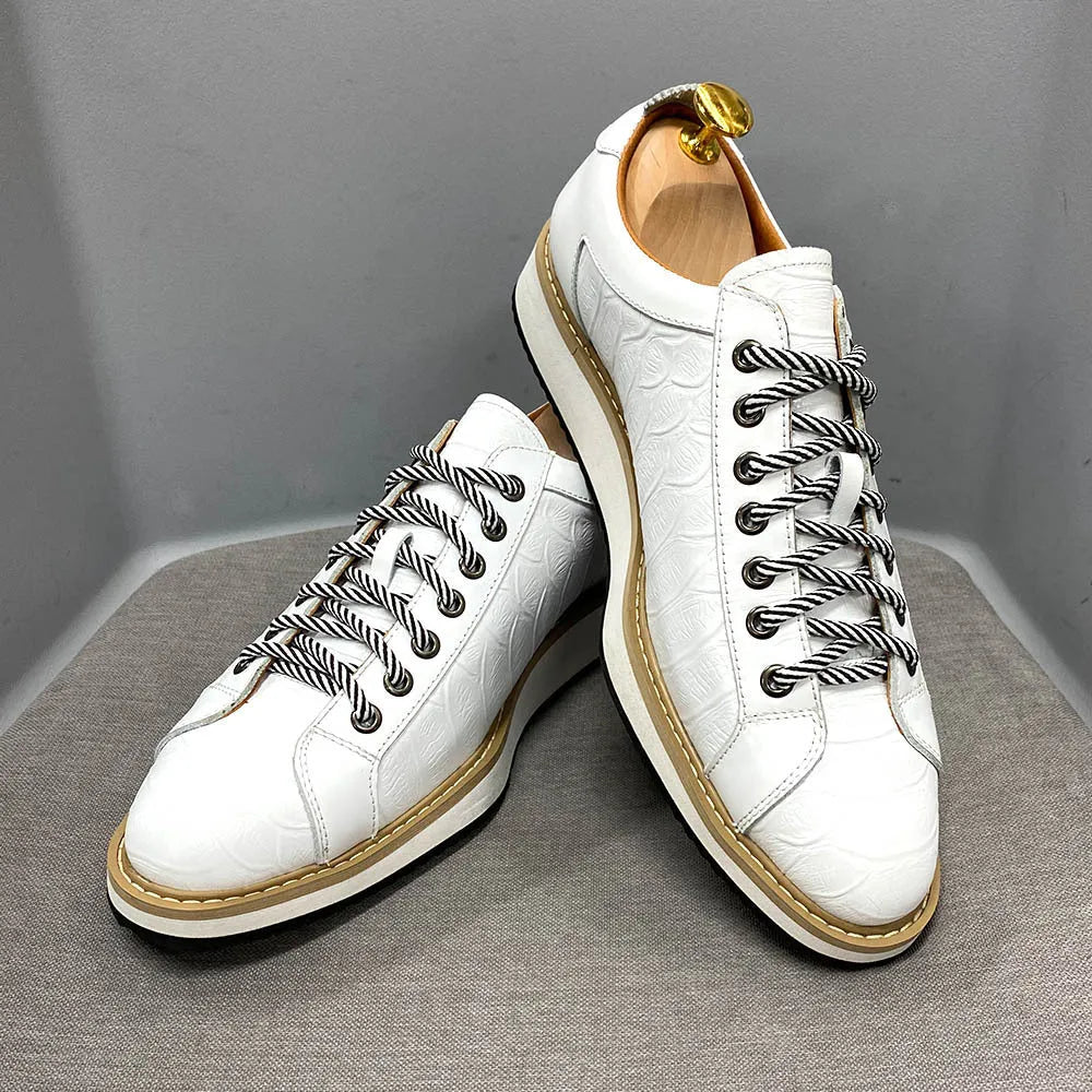 Men's handmade low-top shoes with embossed pattern detail and front laces.
