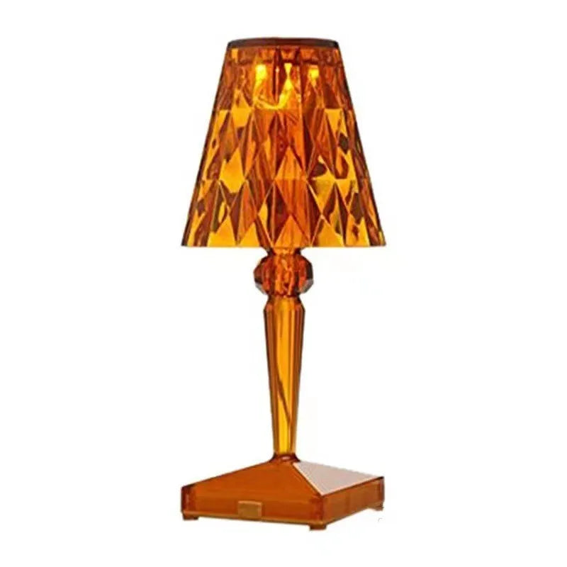 Rose gold portable touch projection night light on a surface showing its acrylic construction and compact size