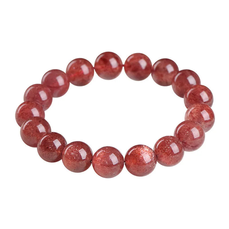 Natural cherry red strawberry quartz bracelet with polished geometric beads on a white background.