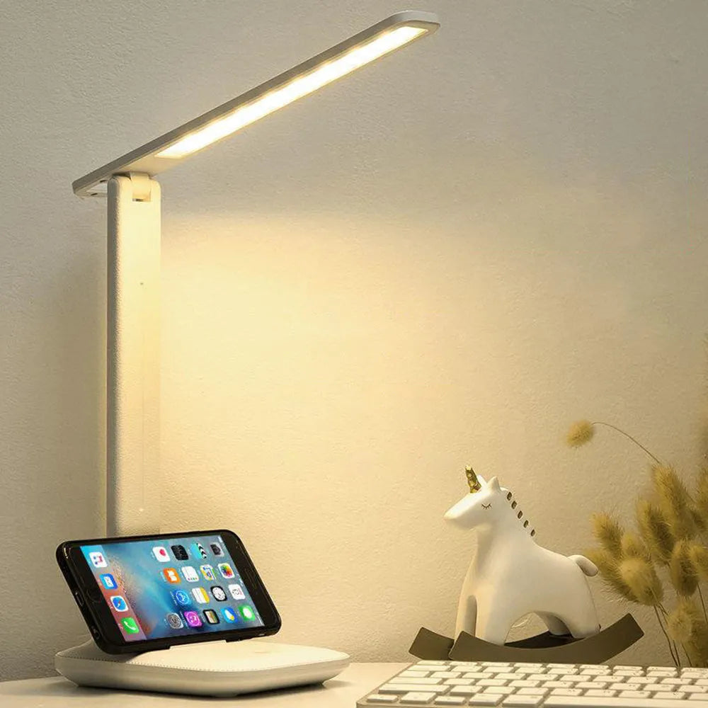 White plastic LED table lamp with touch dimming controls for bedside use