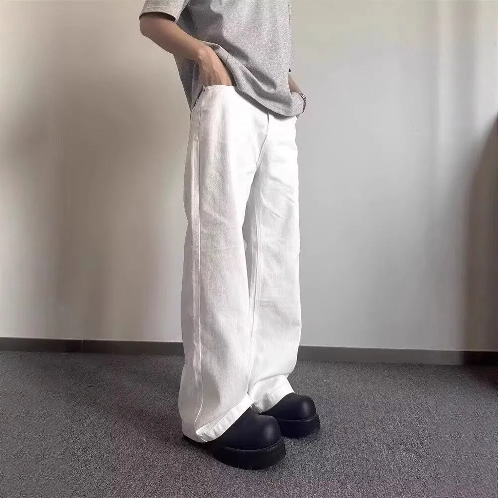 Men's white straight-leg cotton denim jeans on a plain background.