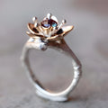 Silver two-tone floral geometric women's alloy ring shown on a finger, demonstrating its design and fit.
