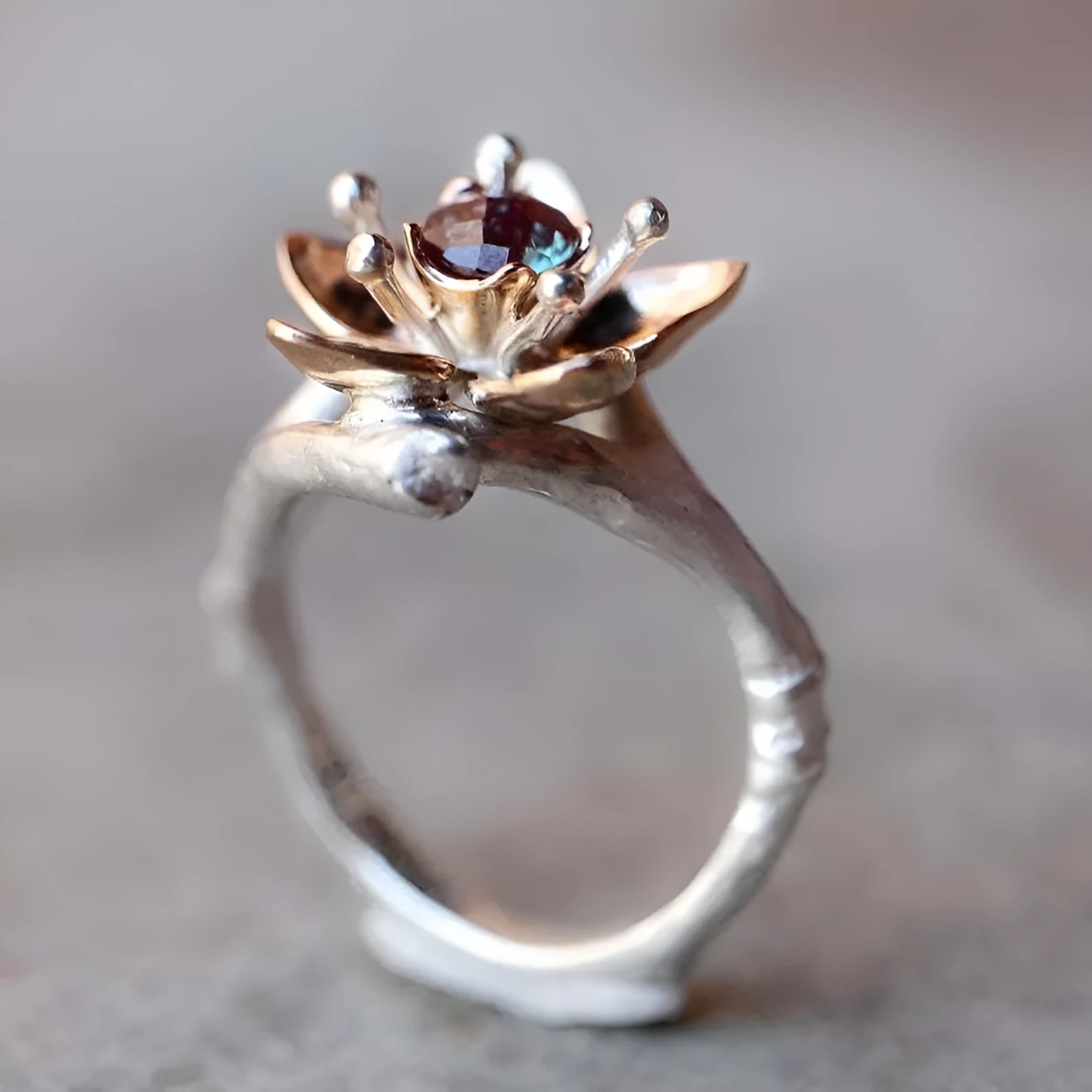 Silver two-tone floral geometric women's alloy ring shown on a finger, demonstrating its design and fit.
