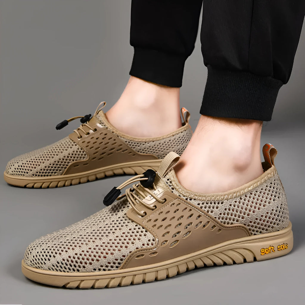Men's black casual sports shoes with mesh upper and elastic band, displayed from side view