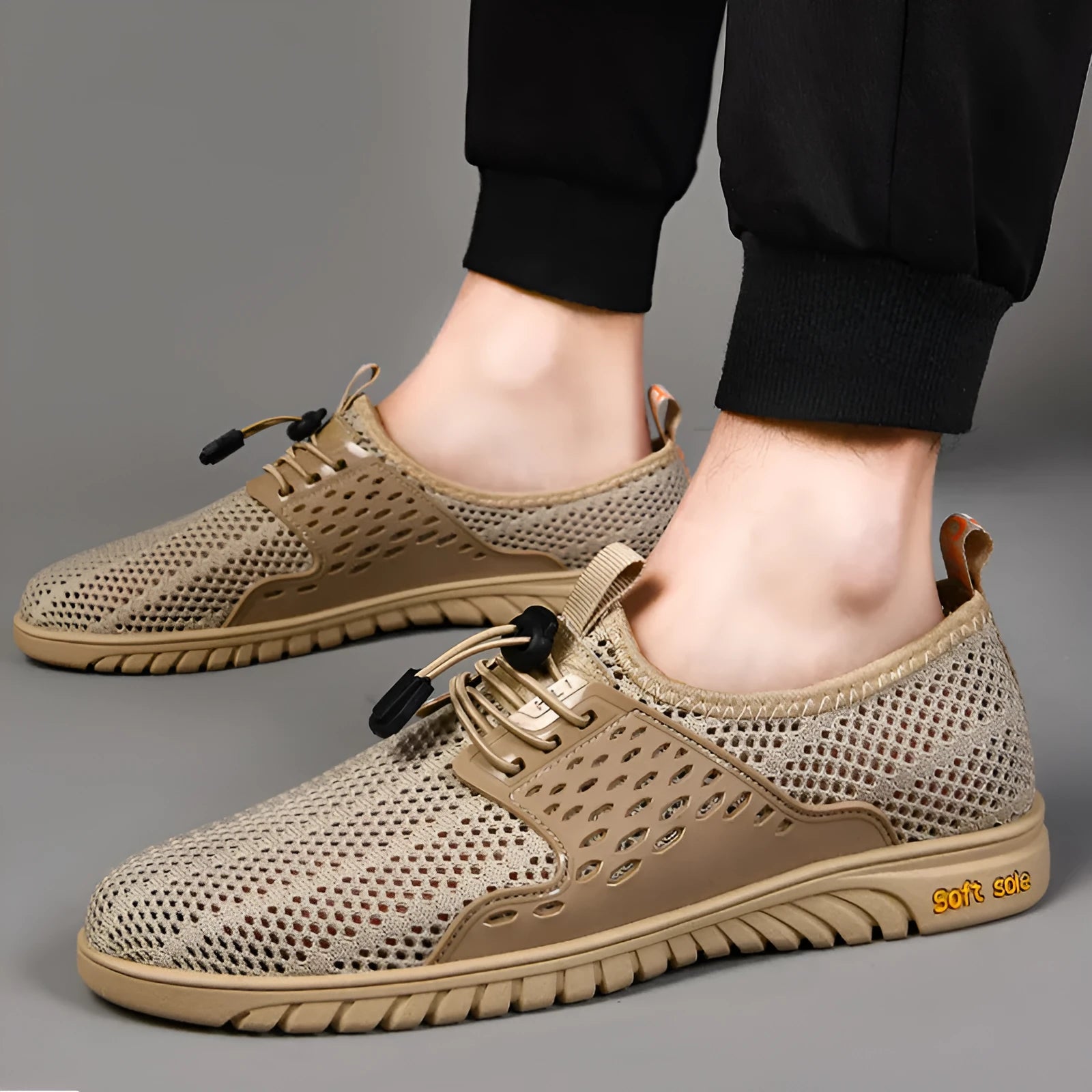 Men's black casual sports shoes with mesh upper and elastic band, displayed from side view