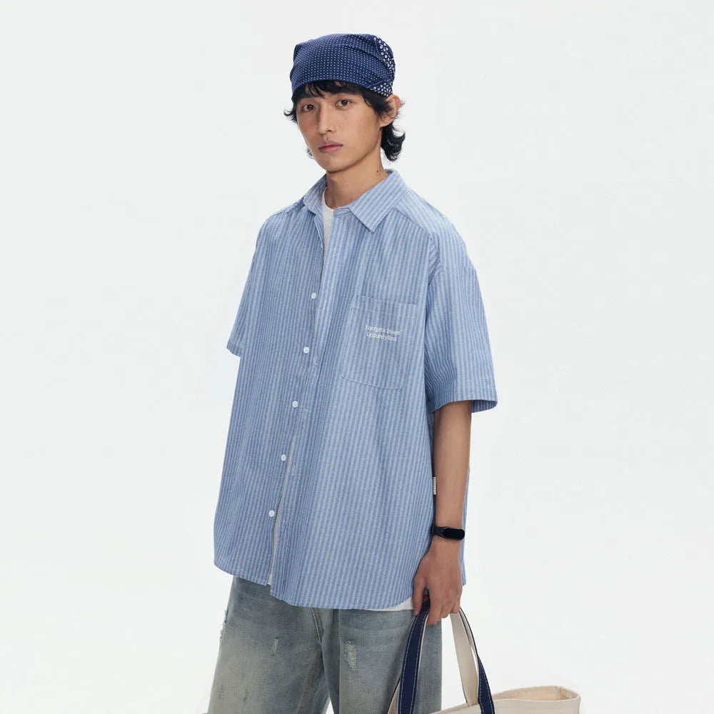 Blue and white striped loose-fitting short-sleeved shirt on a hanger